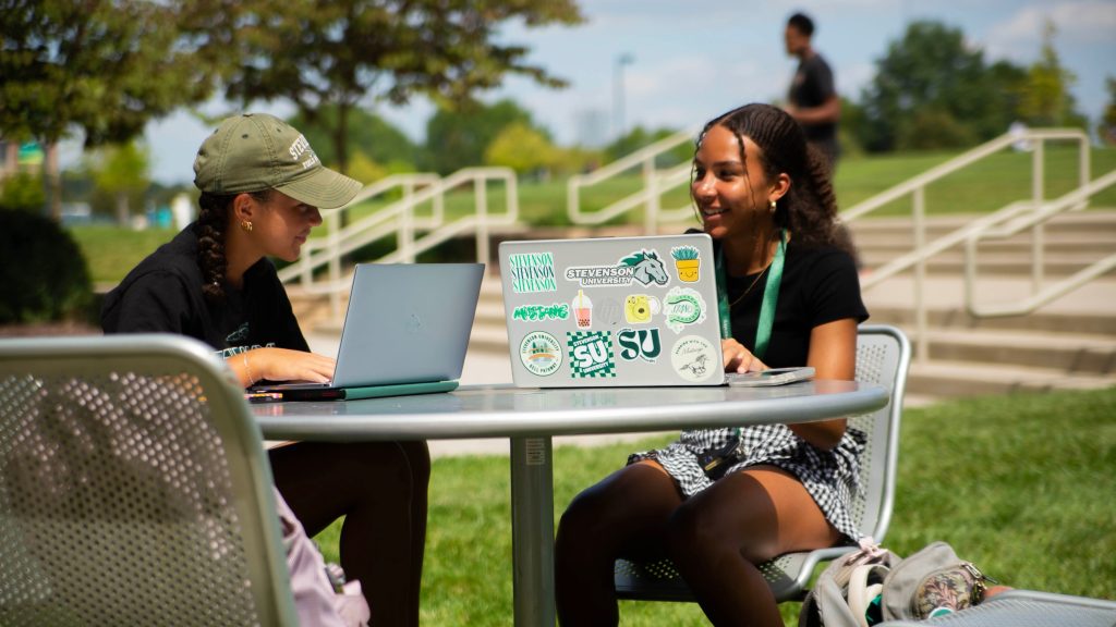 students sitting outside