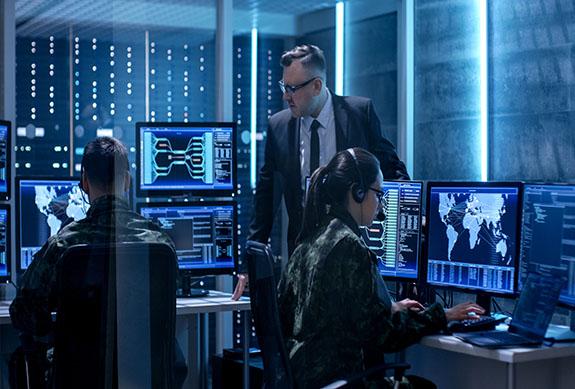 People work on computers in server room